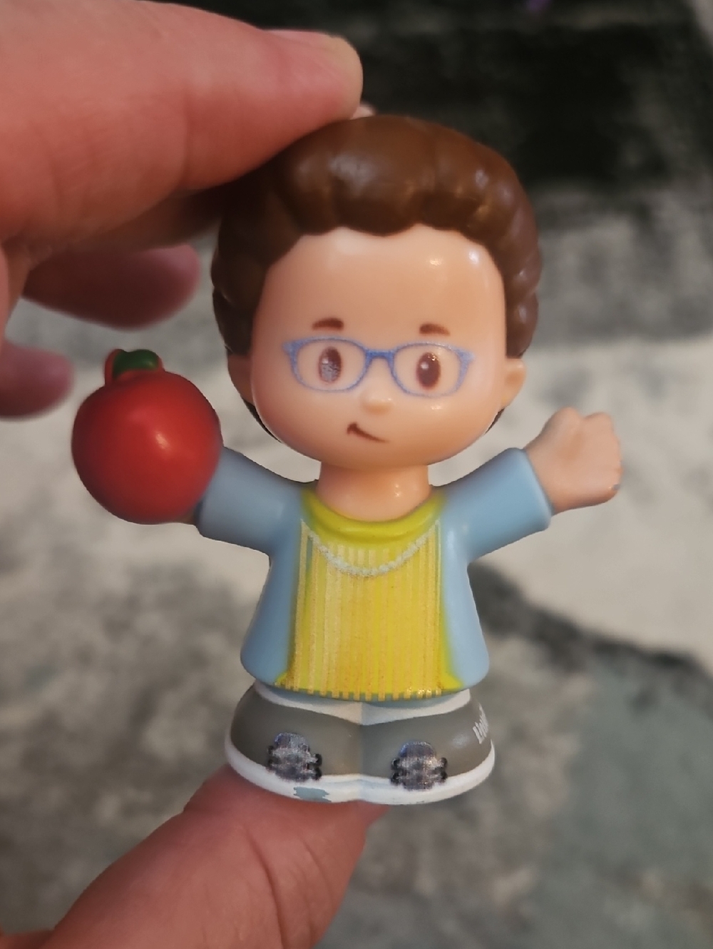 Fisher-Price Little People female teacher figure carrying a red apple